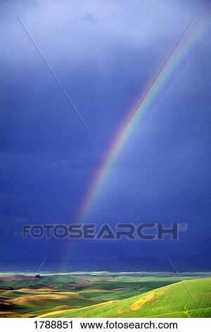 Rainbow over rolling hills View Large Photo Image Stock Image - Rainbow over rolling hills. Fotosearch