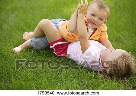 Siblings playing together View Large Photo Image Stock Image - Siblings playing together. Fotosearch