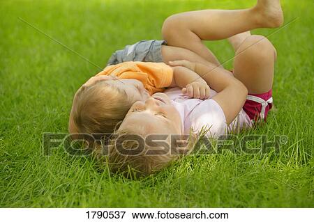Stock Photo - Siblings resting together. Fotosearch