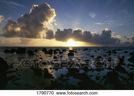 Silhouetted rocks on sunset beach View Large Photo Image Stock Image - Silhouetted rocks on sunset beach. Fotosearch