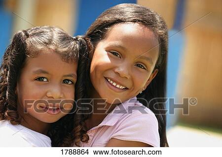 Picture - Sisters Hugging. Fotosearch