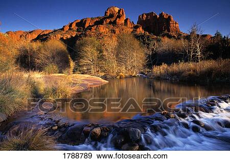Stock Photo - Small cascade and still stream at Red Rock Crossing. Fotosearch