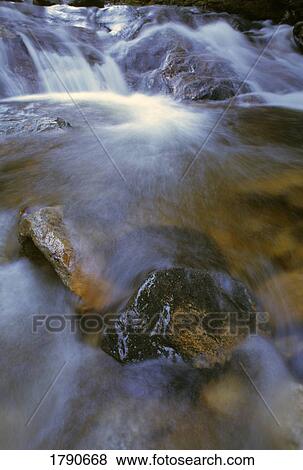Stream rushing over rocks View Large Photo Image Stock Photo - Stream rushing over rocks. Fotosearch