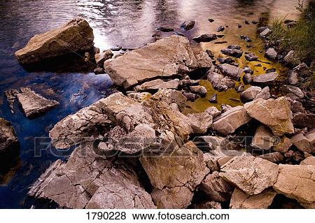 Sunset reflection at water's edge View Large Photo Image Stock Photo - Sunset reflection at water's edge. Fotosearch