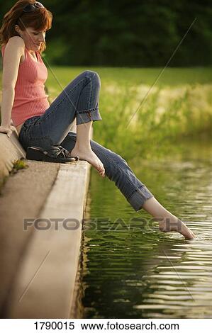 Woman dipping her toe in water View Large Photo Image Stock Photography - Woman dipping her toe in water. Fotosearch