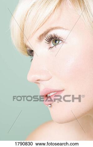 Stock Image - Woman with lip piercings. Fotosearch