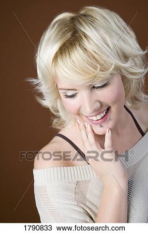 Stock Image - Woman with lip piercings. Fotosearch