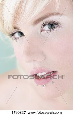 Stock Photo - Woman with lip piercings. Fotosearch