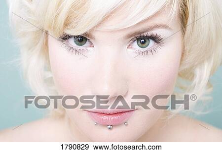 Stock Photo - Woman with lip piercings. Fotosearch