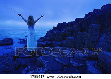 Stock Photo - Woman Worshipping by the sea. Fotosearch