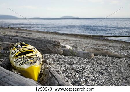 Yellow kayak on beach View Large Photo Image Stock Photo - Yellow kayak on beach. Fotosearch