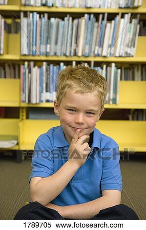 Stock Photography - Young boy in library. Fotosearch