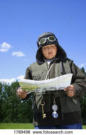 Young explorer reading a map View Large Photo Image Stock Photo - Young explorer reading a map. Fotosearch