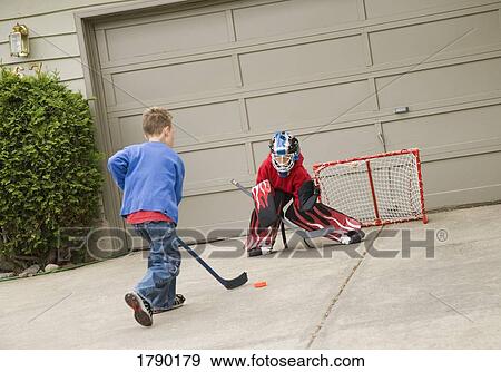 Young goalie anticipating a shot on net View Large Photo Image Stock Photo - Young goalie anticipating a shot on net. Fotosearch