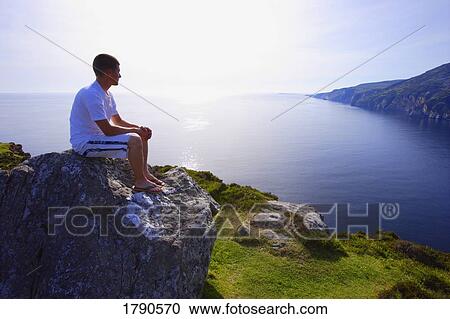 Young man enjoys the view View Large Photo Image Stock Image - Young man enjoys the view. Fotosearch