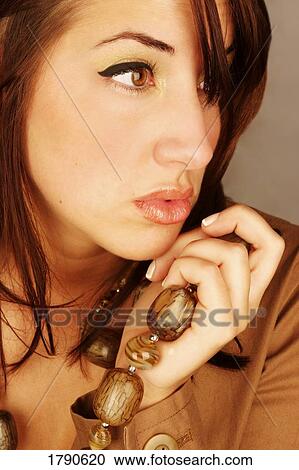 Stock Image - Young woman with necklace. Fotosearch