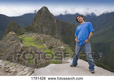 Stock Photo - A man at the ancient Inca ruins of Machu Picchu, Peru. Fotosearch