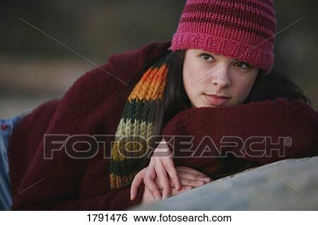 A young woman relaxes at the beach at dusk in Victoria, British Columbia, Canada on Vancouver Island. View Large Photo Image Stock Photograph - A young woman relaxes at the beach at dusk in Victoria, British Columbia, Canada on Vancouver Island.. Fotosearch