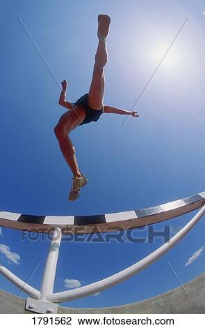 Athlete jumping hurdles View Large Photo Image Stock Image - Athlete jumping hurdles. Fotosearch