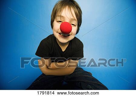 Boy wearing a clown nose View Large Photo Image Picture - Boy wearing a clown nose. Fotosearch