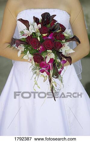 Stock Photo - Bride's bouquet and wedding dress. Fotosearch