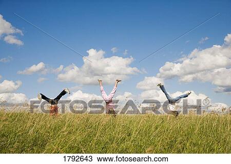 Children doing cartwheels in field View Large Photo Image Stock Image - Children doing cartwheels in field. Fotosearch
