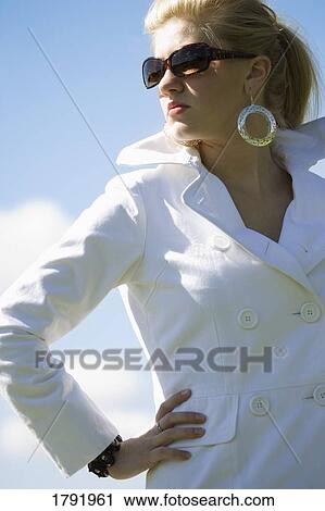 Stock Image - Female wearing sunglasses. Fotosearch