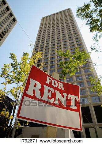 Stock Image - For rent sign in front of apartments buildings. Fotosearch