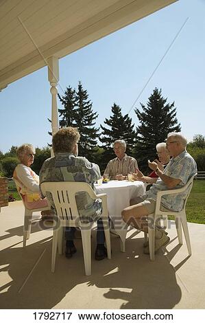 Friends socializing View Large Photo Image Stock Photo - Friends socializing. Fotosearch