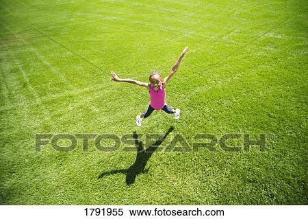 Stock Photography - Girl jumping in excitement. Fotosearch
