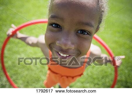 Girl playing with hula hoop View Large Photo Image Stock Photo - Girl playing with hula hoop. Fotosearch