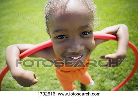 Girl playing with hula hoop View Large Photo Image Stock Photograph - Girl playing with hula hoop. Fotosearch