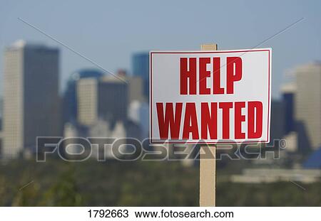 Stock Image - Help wanted sign with city skyline in background. Fotosearch