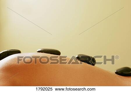 Stock Photography - Hot stone massage. Fotosearch