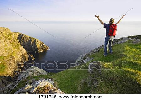 Man at the top of a cliff View Large Photo Image Stock Photography - Man at the top of a cliff. Fotosearch