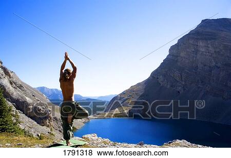 Man doing yoga in nature View Large Photo Image Stock Photo - Man doing yoga in nature. Fotosearch