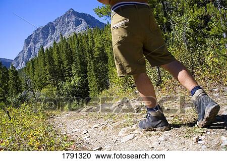 Man hiking on mountain trail View Large Photo Image Stock Image - Man hiking on mountain trail. Fotosearch