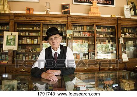 Man in an old fashioned pharmacy View Large Photo Image Stock Photo - Man in an old fashioned pharmacy. Fotosearch