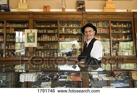 Man in an old fashioned pharmacy View Large Photo Image Stock Photograph - Man in an old fashioned pharmacy. Fotosearch