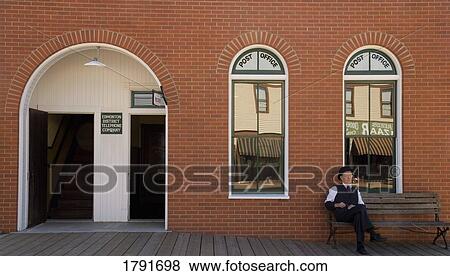 Man in front of an old-fashioned post office View Large Photo Image Stock Photo - Man in front of an old-fashioned post office. Fotosearch