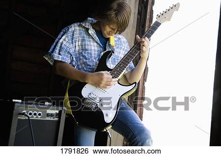 Stock Photograph - Man playing guitar. Fotosearch