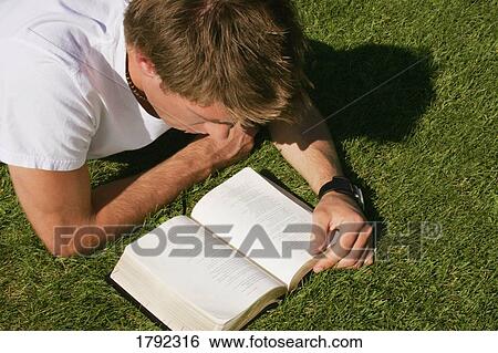 Stock Photograph - Man reading the Bible outside. Fotosearch