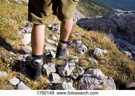 Man walking among rocks on mountain View Large Photo Image Stock Photo - Man walking among rocks on mountain. Fotosearch