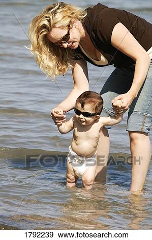 Mother and child wading in lake View Large Photo Image Stock Photo - Mother and child wading in lake. Fotosearch