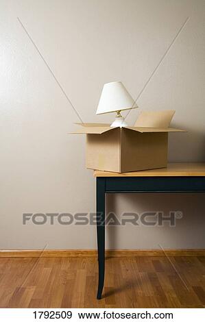 Stock Photo - Moving box on a table. Fotosearch