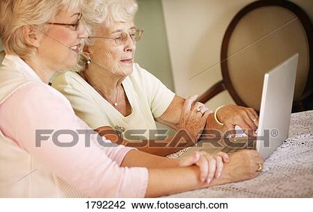 Older women with technology View Large Photo Image Stock Image - Older women with technology. Fotosearch