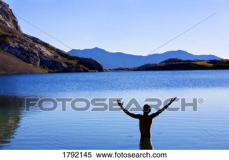 Person worshipping in mountain lake View Large Photo Image Stock Photography - Person worshipping in mountain lake. Fotosearch