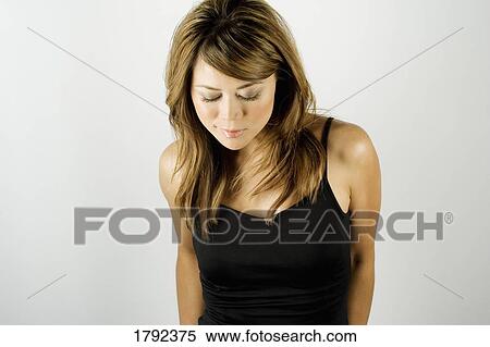 Stock Photography - Portrait of woman looking down. Fotosearch