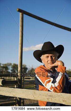 Rancher leaning on a corral View Large Photo Image Picture - Rancher leaning on a corral. Fotosearch