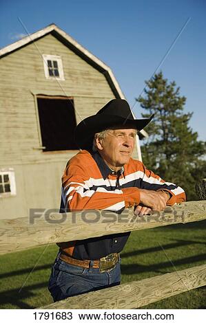 Rancher leaning on a corral View Large Photo Image Stock Image - Rancher leaning on a corral. Fotosearch